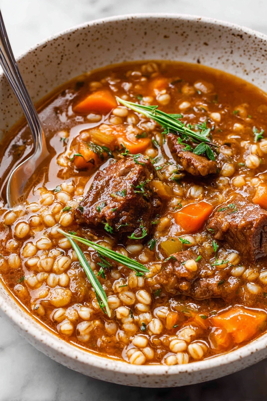 A white bowl filled with thick stew that has three main layers of large dark brown meat chunks, small round light beige grains, and bright orange baby carrots mixed throughout. The stew is covered in a shiny, slightly thick brown broth with green herbs sprinkled in and a sprig of fresh green thyme resting on top towards one side. A silver spoon is placed inside the bowl on the right side, with its handle stretching out. The bowl is set on a white marbled surface. Photo taken with an iphone --ar 2:3 --v 7