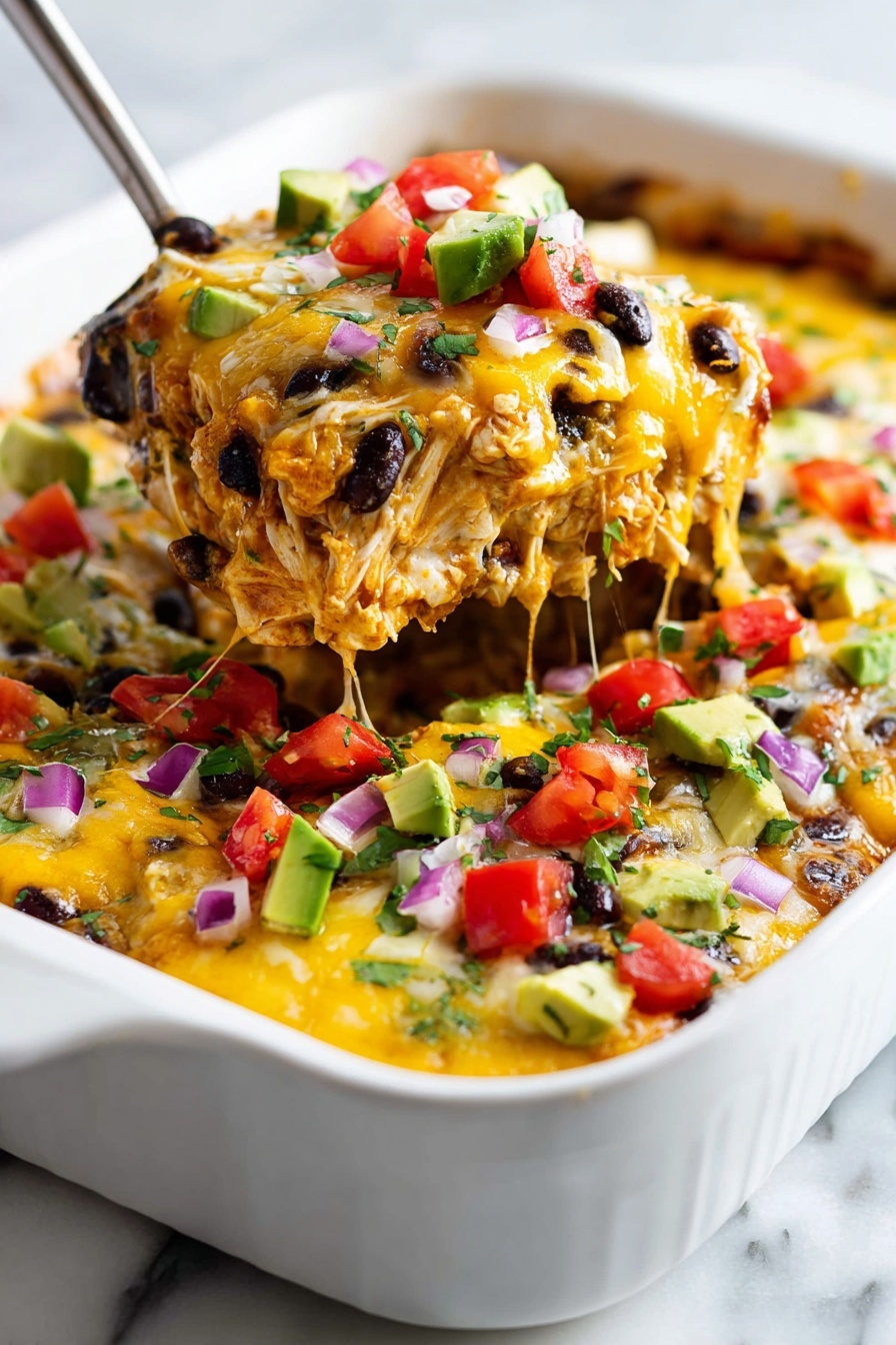 A close-up view of a white baking dish filled with a layered cheesy casserole. The bottom layer contains shredded chicken mixed with black beans and a gooey melted yellow cheese, creating a rich and creamy texture. On top, there are diced red tomatoes, green jalapenos, small cubes of avocado, and finely chopped red onions, adding bright colors of red, green, and purple with a fresh, chunky texture. The casserole is being scooped up by a metal spatula, lifting a thick, colorful portion that shows the melted cheese stretching slightly. The dish sits on a white marbled surface. Photo taken with an iphone --ar 2:3 --v 7