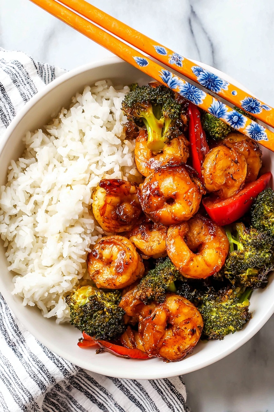 A white bowl holds a meal with two main parts: on one side is a serving of fluffy white rice with a soft texture, and on the other side are large, grilled shrimp with a shiny, orange-brown glaze that shows char marks. Mixed in with the shrimp are bright green broccoli pieces and slices of red bell pepper, adding color and crunch to the dish. Orange chopsticks with blue and white floral patterns rest on the bowl's top edge. The whole bowl is placed on a white marbled surface with part of a striped cloth visible next to it. Photo taken with an iphone --ar 2:3 --v 7