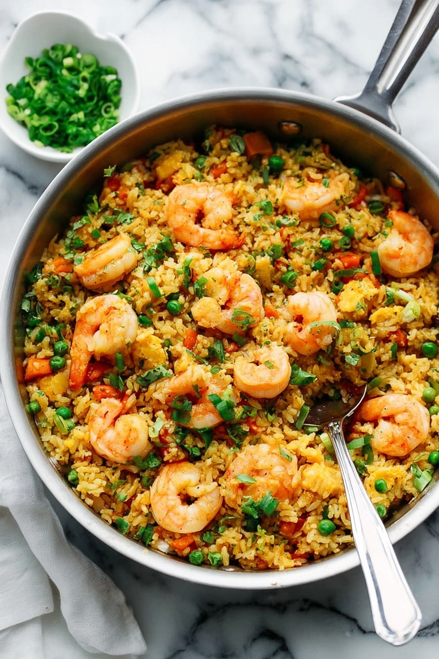 A large metal pan filled with fried rice topped with many pinkish-orange shrimp. The rice is yellowish with small bits of green peas and orange carrots mixed in. Chopped green onions are sprinkled on top, adding a fresh green color. A metal spoon sits inside the pan, ready to serve. In the background, there is a small white bowl with chopped green onions on a white marbled surface. photo taken with an iphone --ar 2:3 --v 7