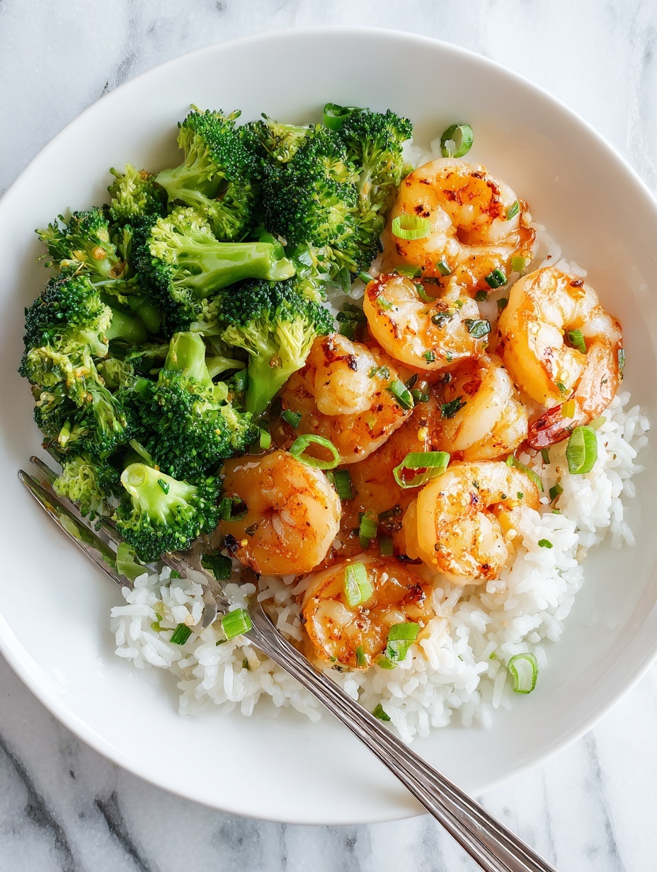 A white plate holds a dish with three layers: the bottom layer is white rice with separate grains, on top of that there are bright green broccoli florets with a fresh texture, and the top layer shows several large shrimp cooked to an orange color with a slight char and a shiny glaze. The shrimp are sprinkled with small pieces of chopped green onion. A silver fork rests at the edge of the plate. The scene is on a white marbled surface. photo taken with an iphone --ar 2:3 --v 7